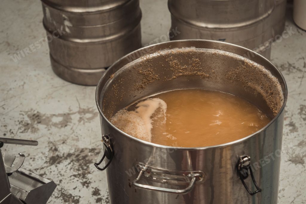 A high angl shot of the beer brewing process with boiling the wort