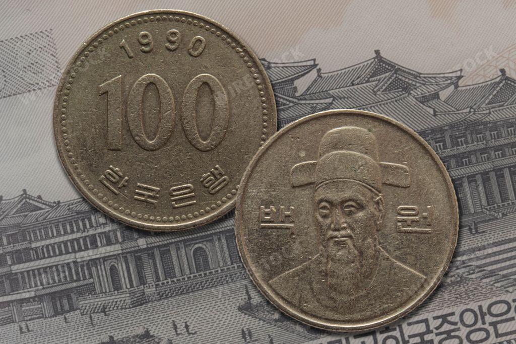 Silver Japanese Yen coins on a paper