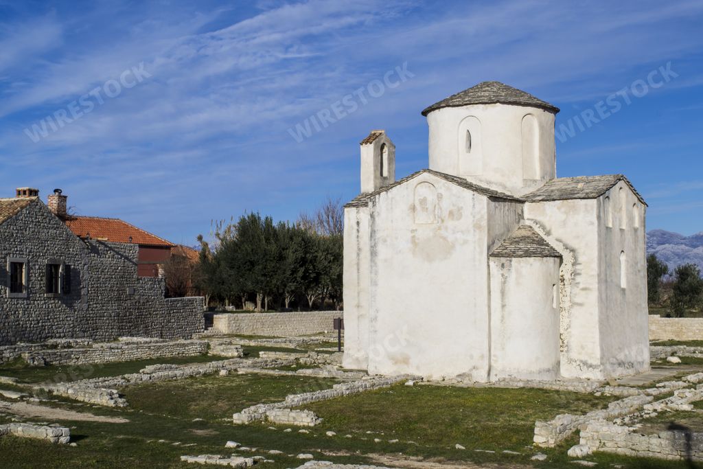panoramic shot of the Church of Holy Cross in Nin Croatia against a blue cloudy sky