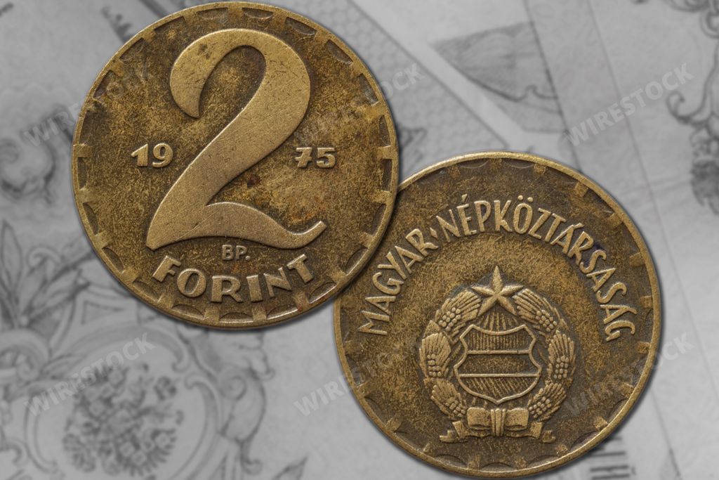 Two Hungarian forint coins from 1975 on a paper background.