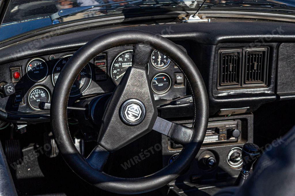 An interior view of a vintage MGB two-door sports car from the 1960s