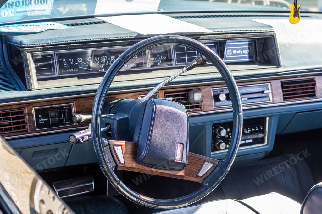 An interior view of an Oldsmobile 98 with a dashboard - a vintage luxury American car