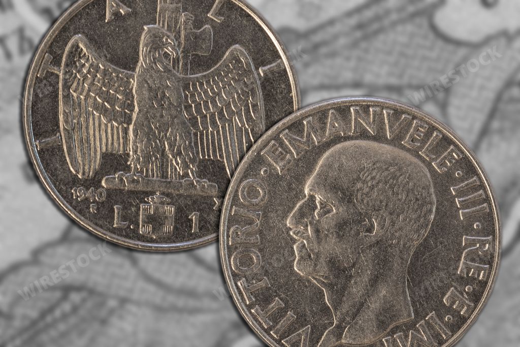 A closeup shot of a Italian lira coins from 1940 with antique diagrams on the background