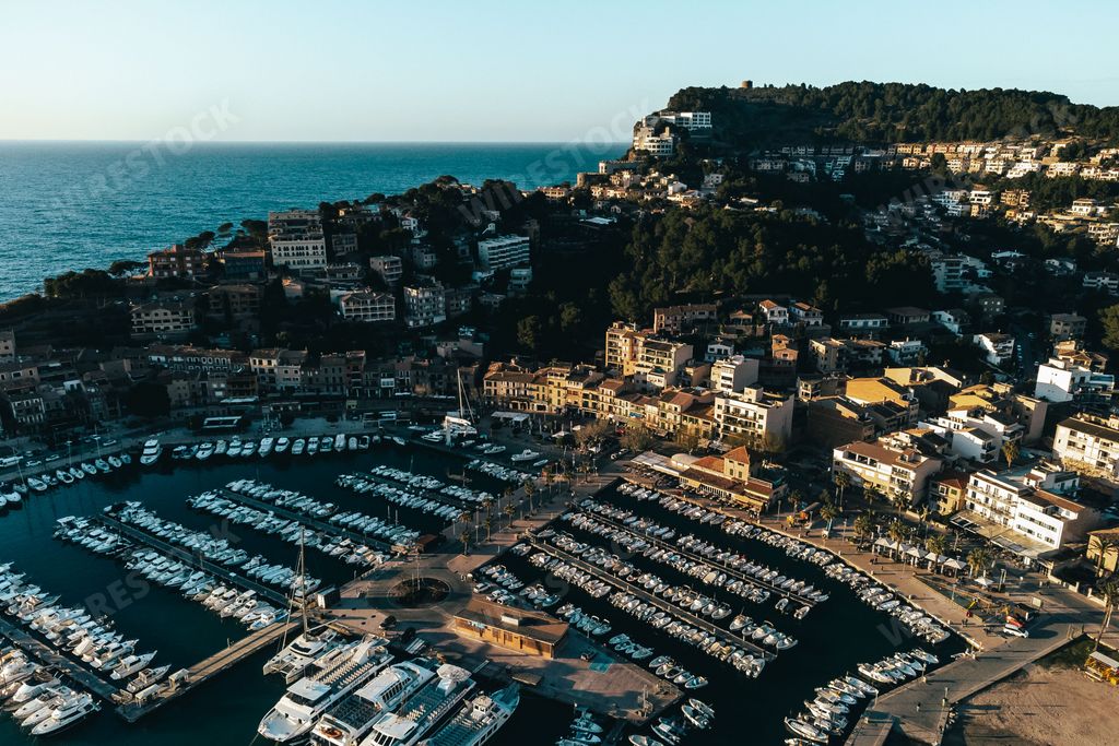 An aerial view of boats in the harbor in Mallorca, Spain with the city in the background
