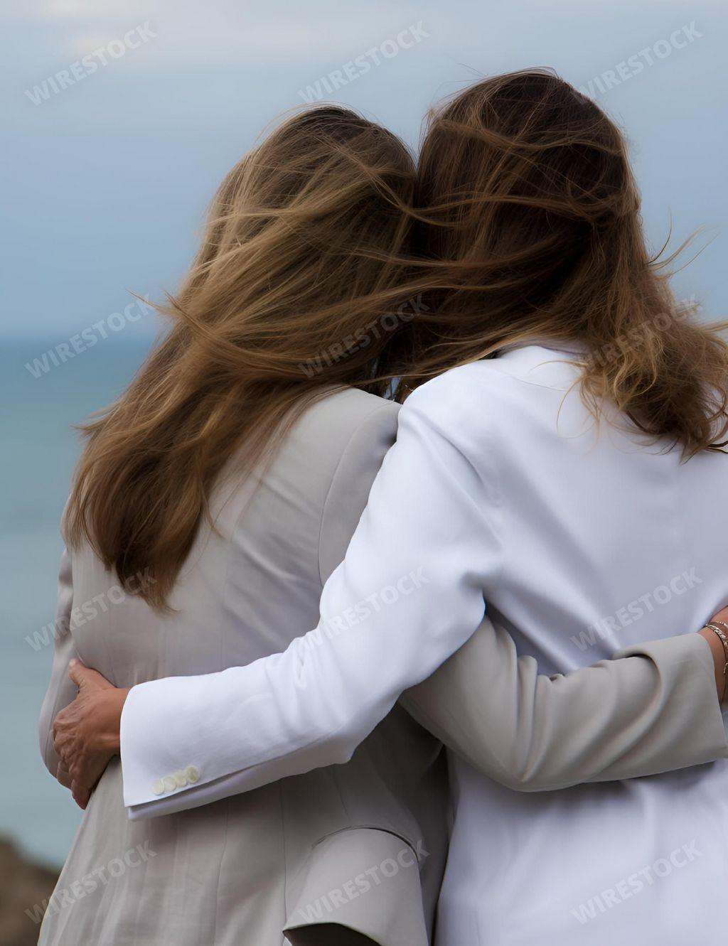 An AI generated illustration of Two female friends standing side by side, embracing each other in a warm hug, with a stunning blue ocean backdrop