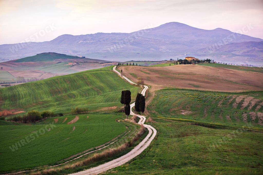 A landscape of hills covered in farm fields in Tuscany, Italy