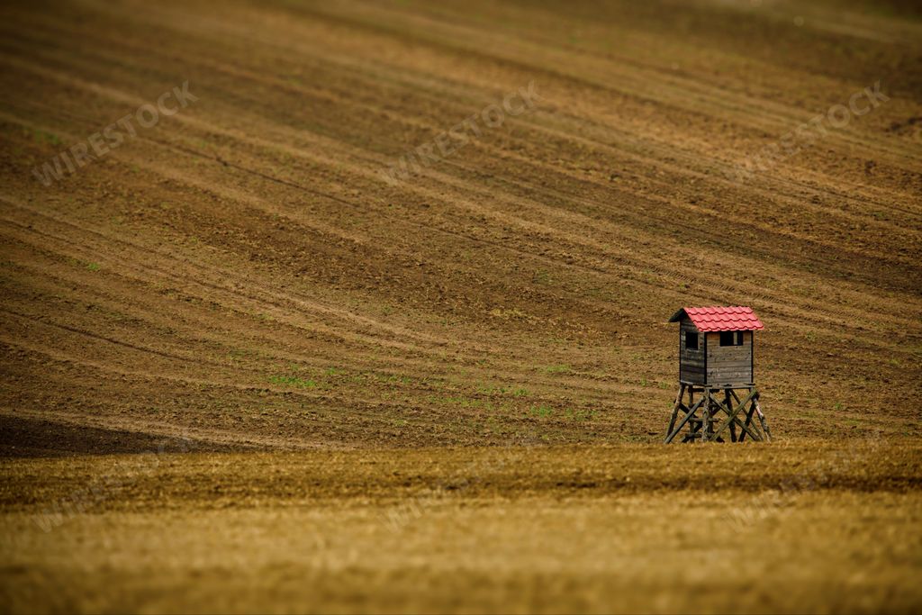 An old small wooden watchtower on a farm field in Moravia, the Czech Republic