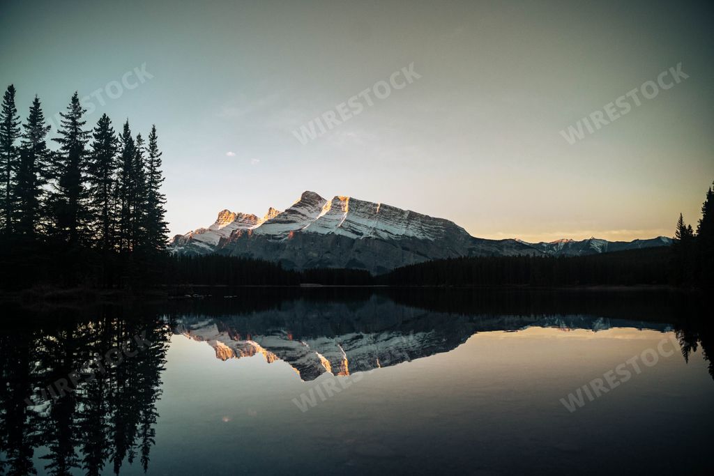 A beautiful picturesque view of Two Jack Lake with a reflection of Mount Rundle