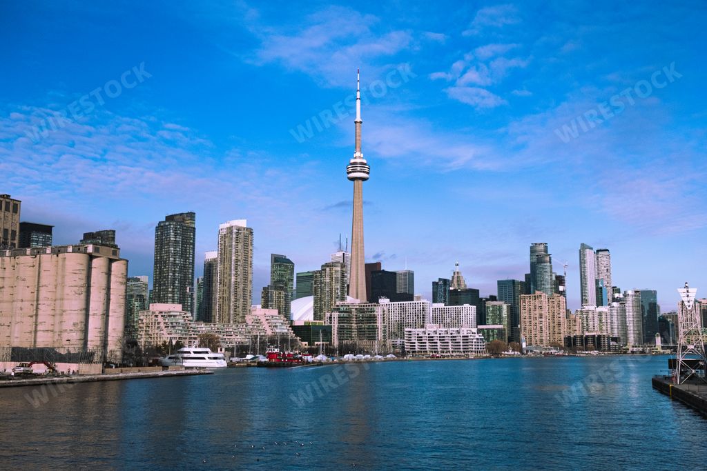 A panorama of Toronto skyline with the famous CN Tower under blue skies