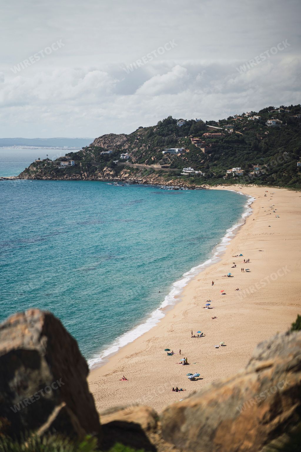 A vertical shot of people relaxing on Bolonia beach in Tarifa, Spain