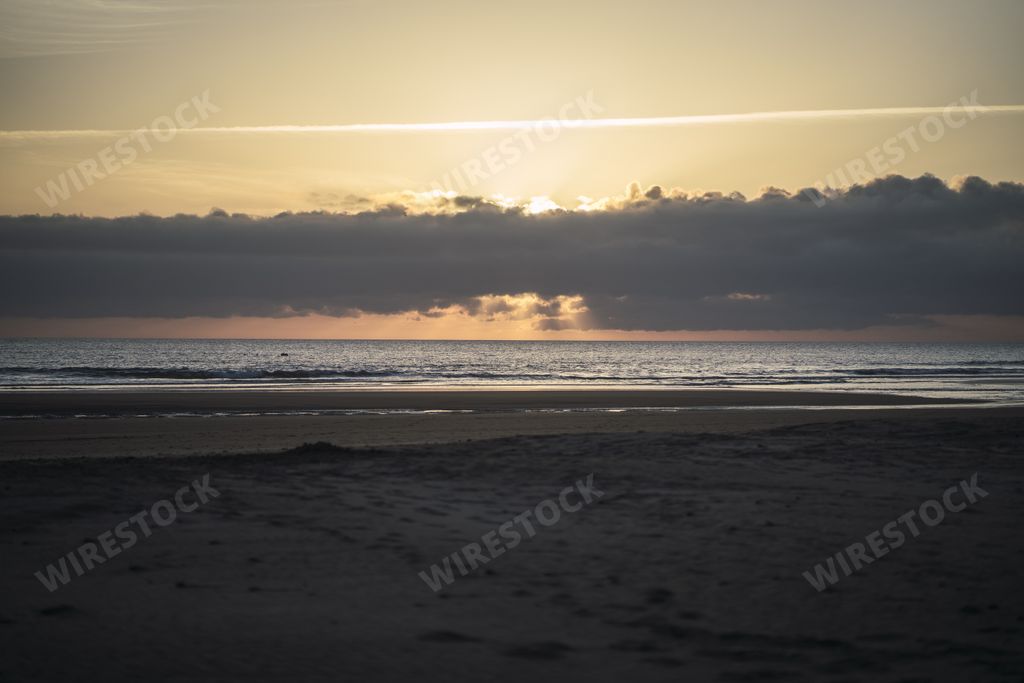 A beautiful view of a sandy beach at sunset