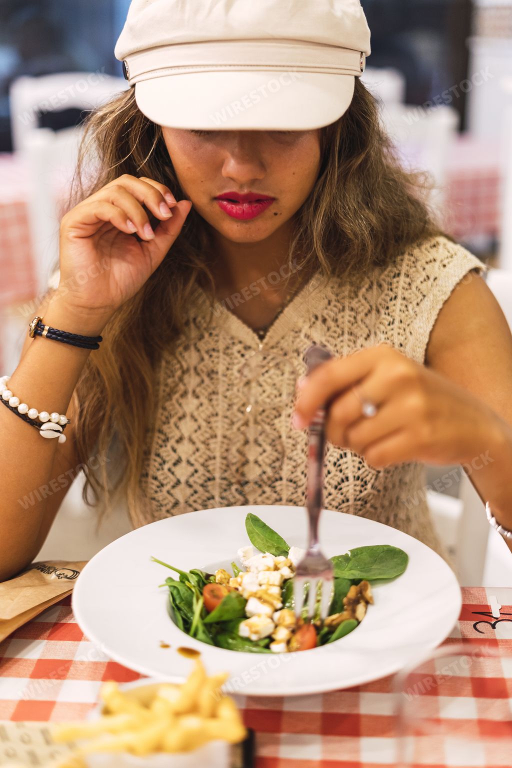 A shallow focus shot of a young mulatto female eating a salad