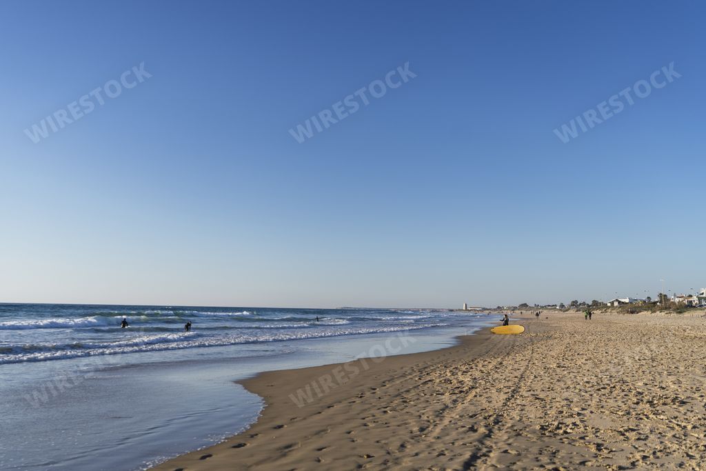 A beautiful view of a sandy beach under a clear blue sky