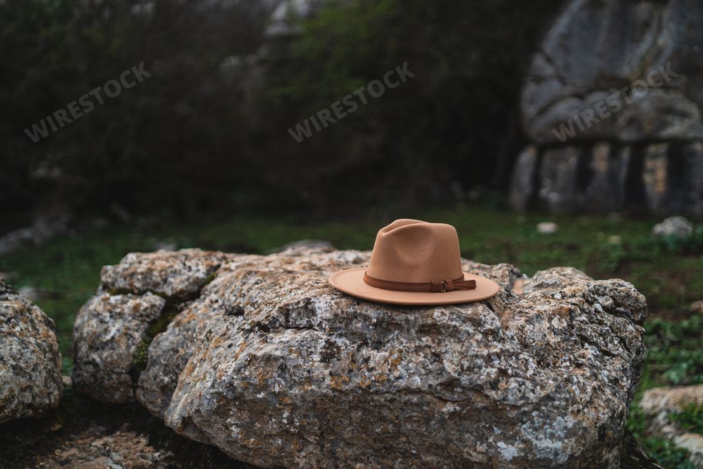 A close-up shot of a hat on a rock during daytime with blurred background in El Torcal de Antequera, Malaga, Spain