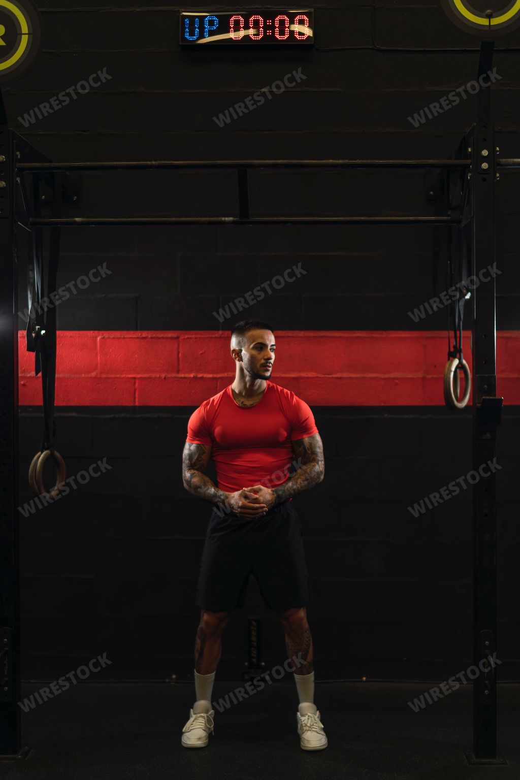 A strong muscular European guy with cool tattoos in a gym crossfit