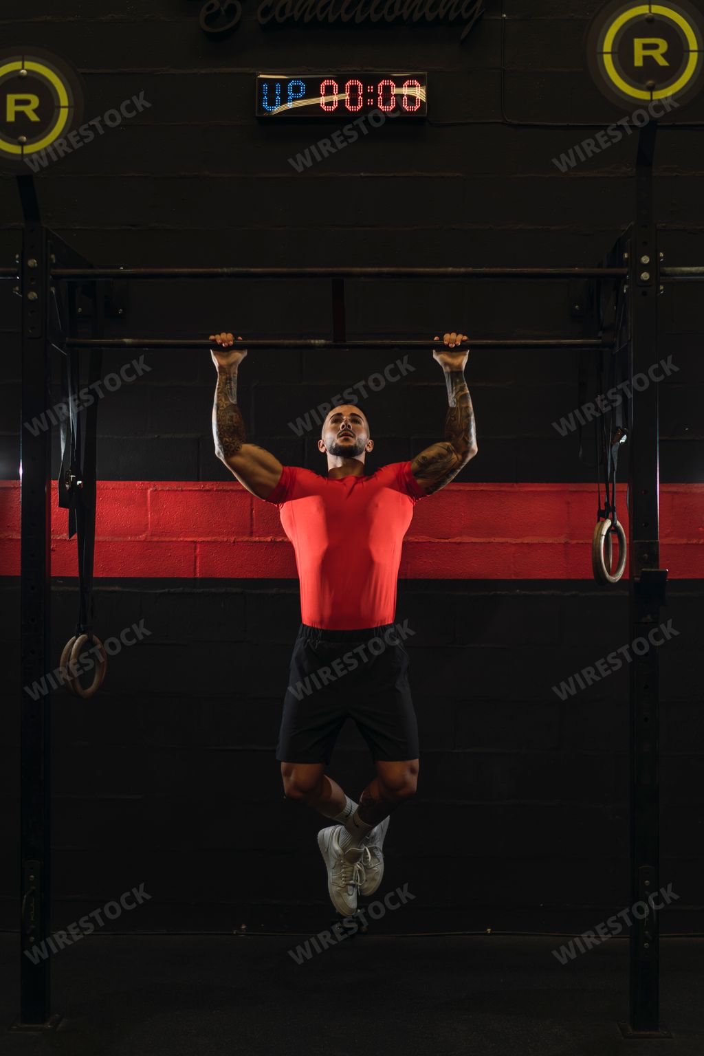 A strong muscular European guy with cool tattoos working out in a gym