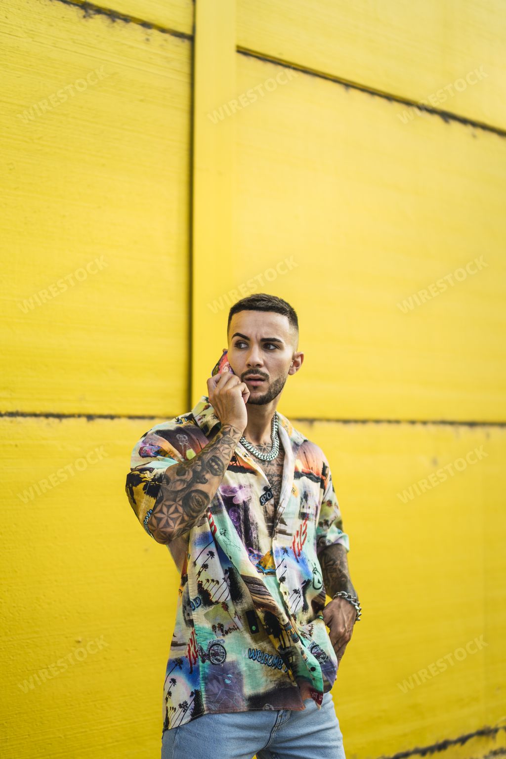 A vertical shot of a handsome male using his cellphone