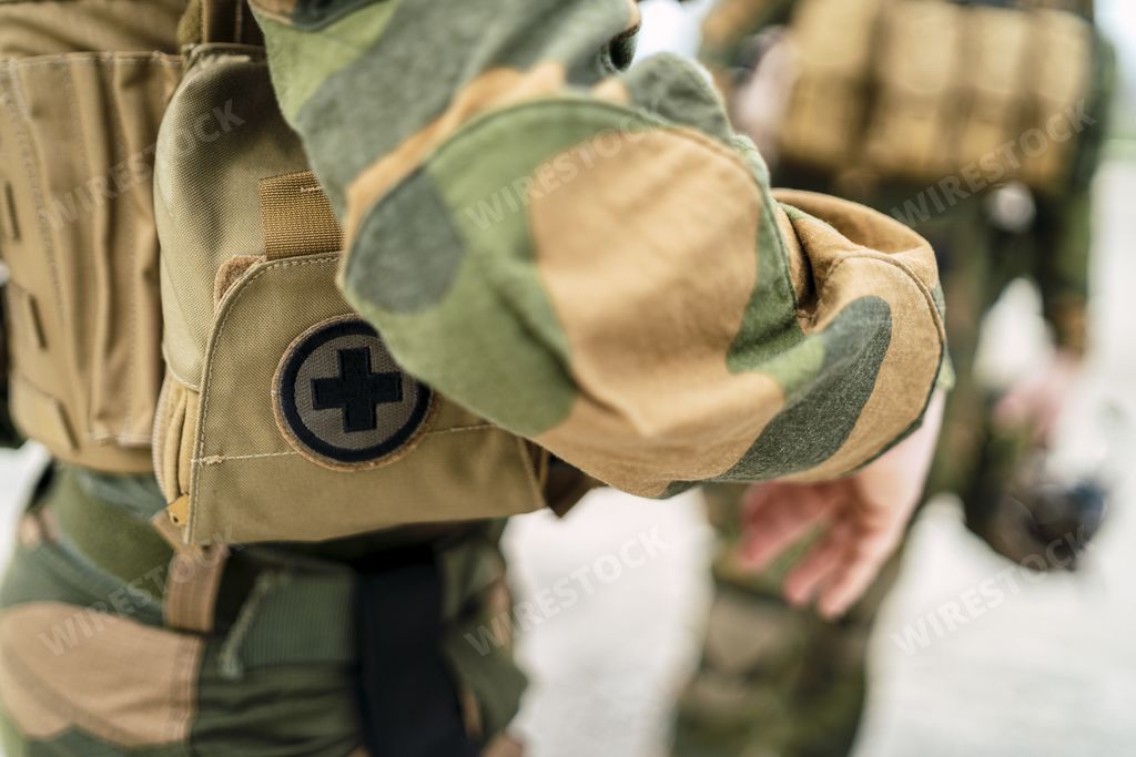 A closeup of a small first aid bag on the uniform of a special force soldier