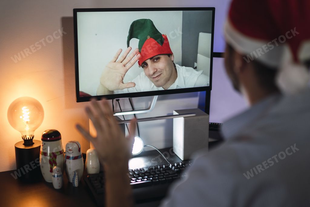 A young boy making video call at Christmas with a mask for prevention of covid 19