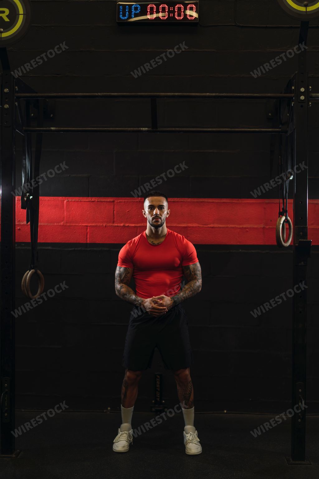 A strong muscular European guy with cool tattoos in a gym crossfit