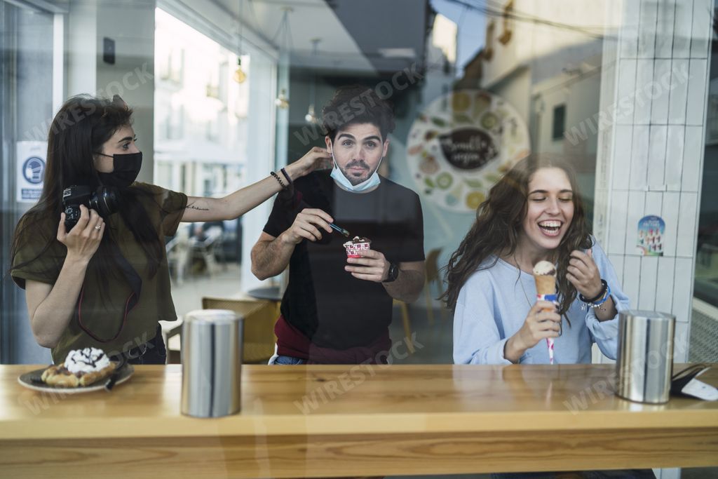 A group of happy Caucasian friends enjoying their time in a coffee house