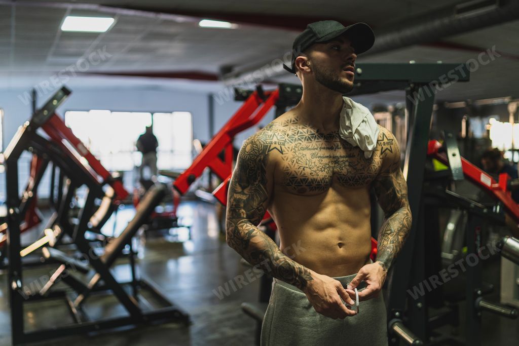 The handsome man doing a workout in the gym