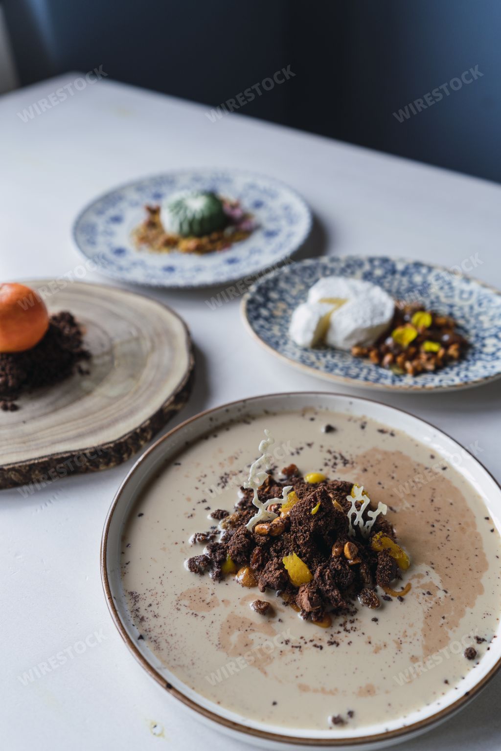 A vertical shot of delicious decorated desserts in plates on the table in a restaurant