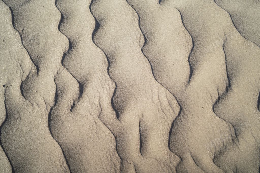 The wavy ripples texture of sand in the beach