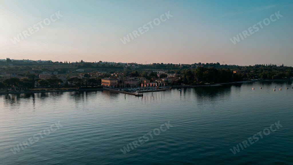 Aerial view of Bardolino, Verona City and Cisano Port on Lake Garda in Italy on a sunny day