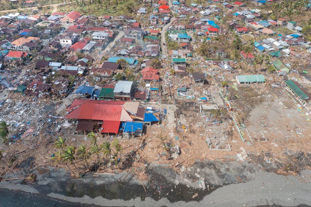 A bird's eye view of houses in a small village with colorful rooftops