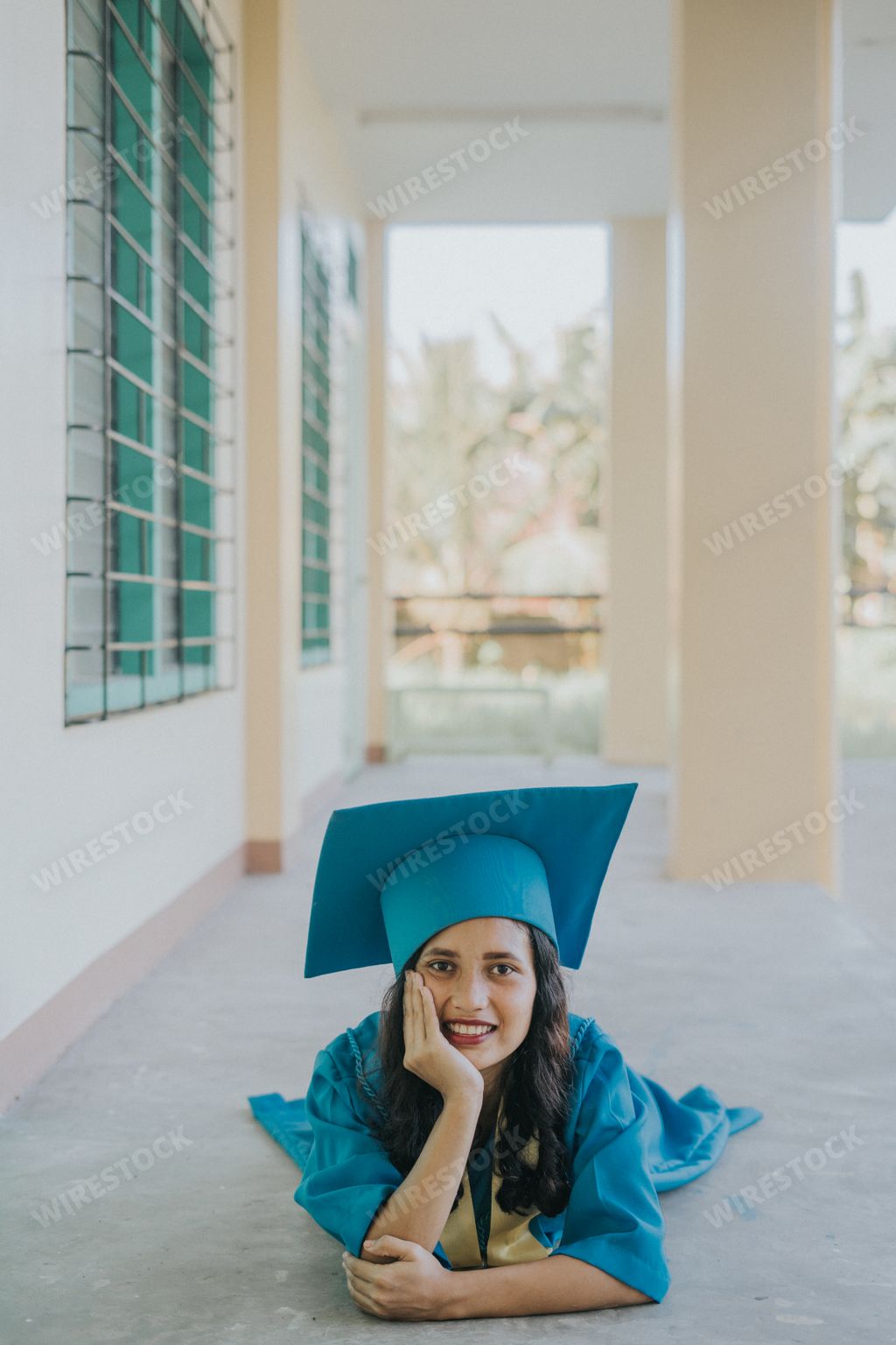 Beautiful Portrait of a Pretty Asian Filipino Woman in her Graduation Cap, Gown, and Sash. Senior Class on University Campus in the Philippines