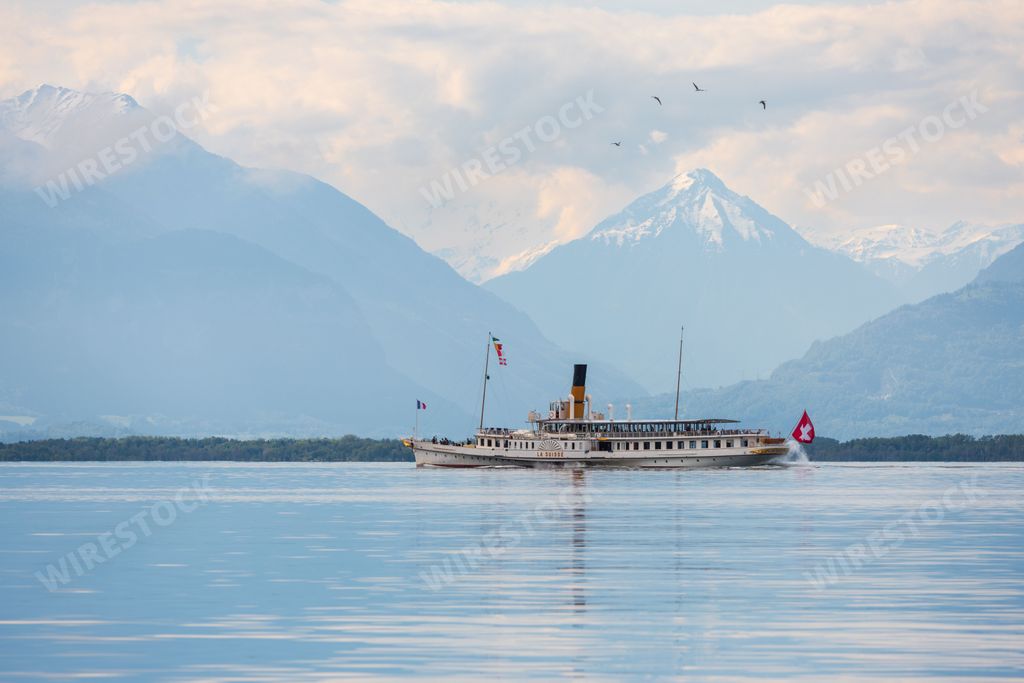Landscape view of the CGN boat "La Suisse" on the Geneva Lake with a mountain range in the background, shot from Vevey, Vaud Switzerland