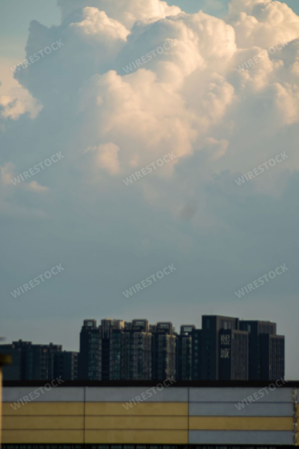 A vertical shot of buildings under a cloudy sky