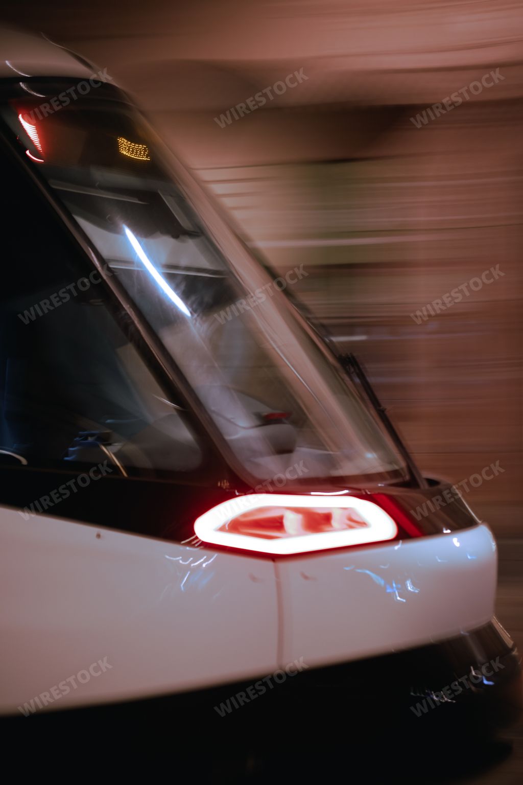 A closeup shot of a high-speed train front part in motion, Strasbourg at night, France