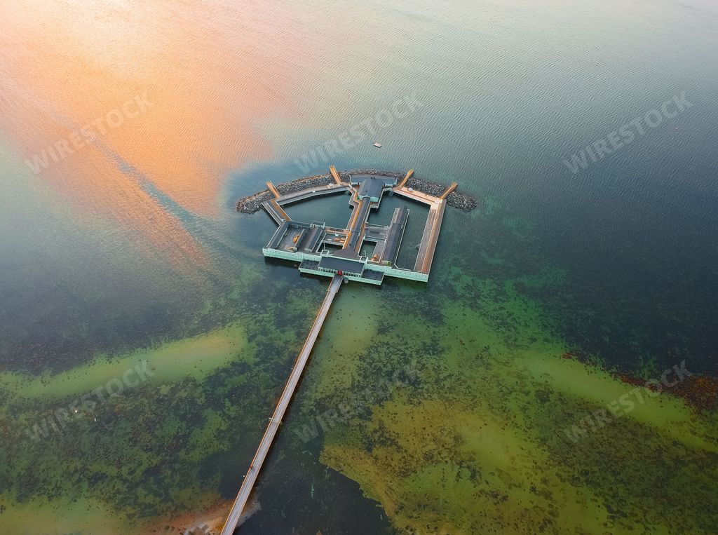An aerial shot of the Ribersborgs Kallbadhus open-air bath in the middle of the water in Malmo, Sweden