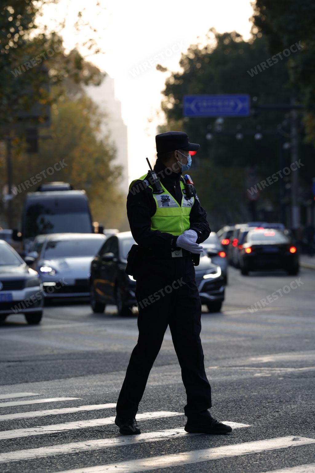 A police officer controlling traffic with a lot of cars in Shanghai