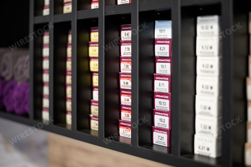 A Hair dye on the black shelf at the beauty salon