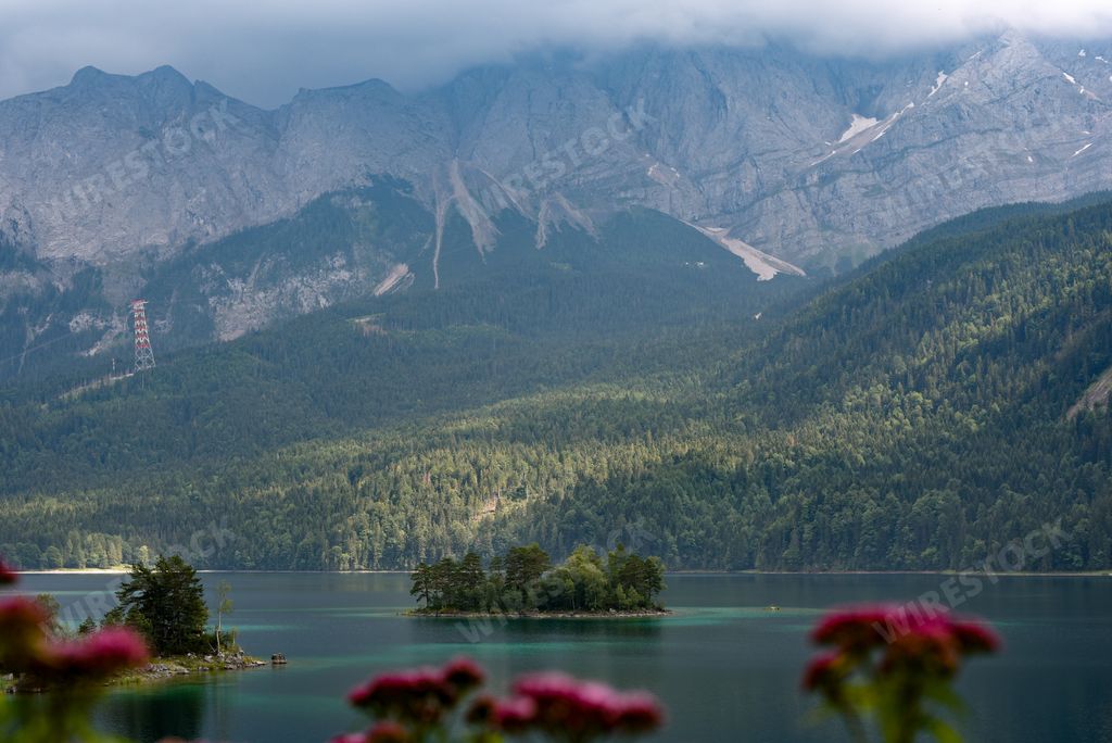 A beautiful shot of greenery-covered hills and mountains near a village in Austria