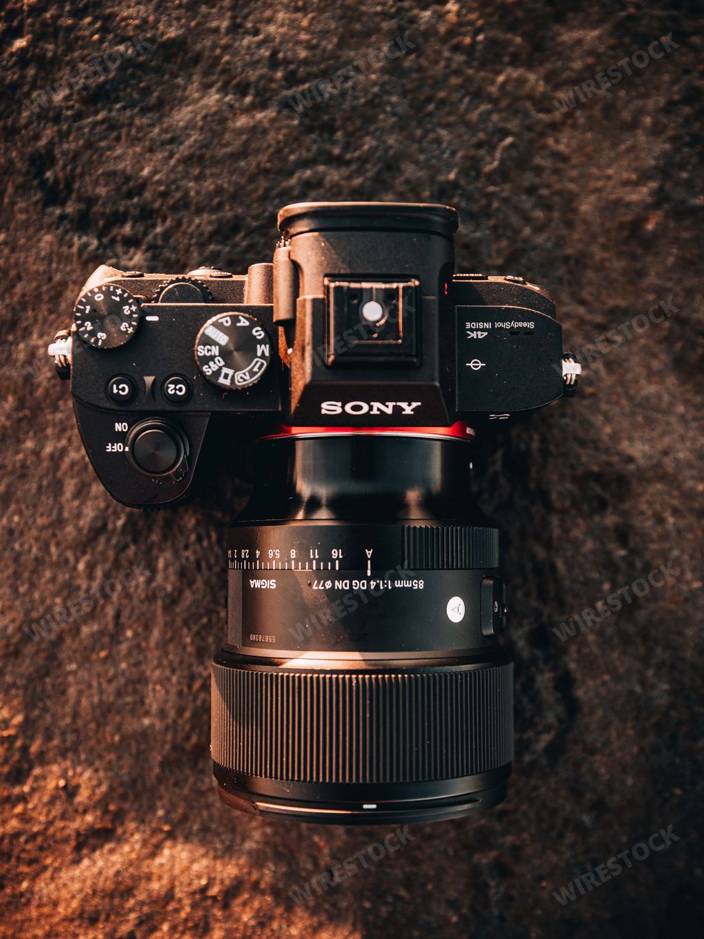 A digital SONY camera on a flat, gray stone slab