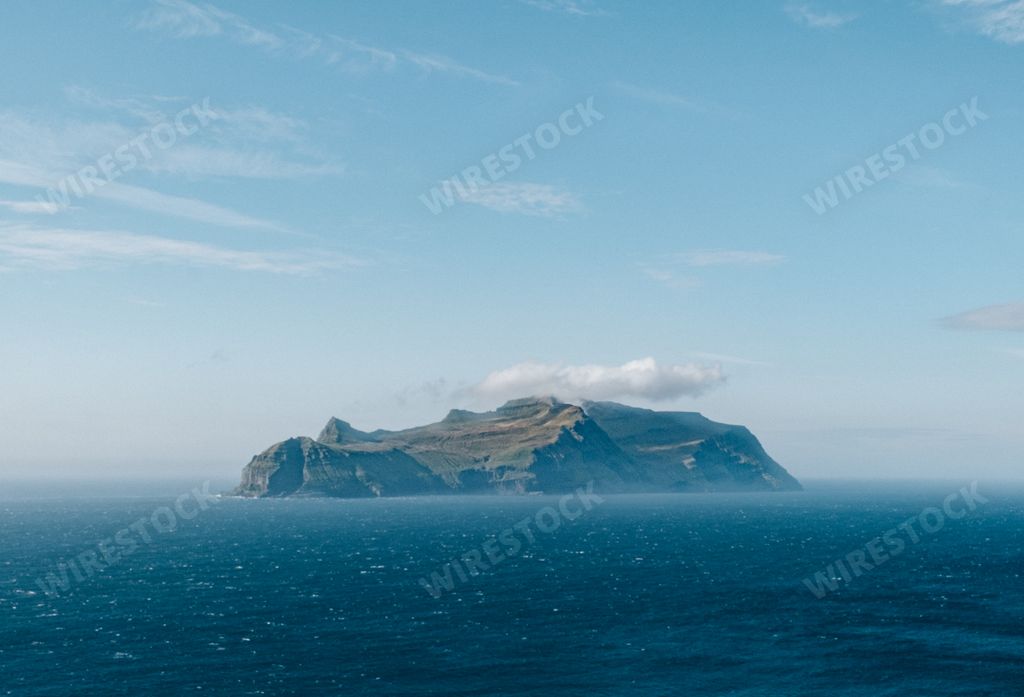 A wide angle shot of an island surrounded by the water