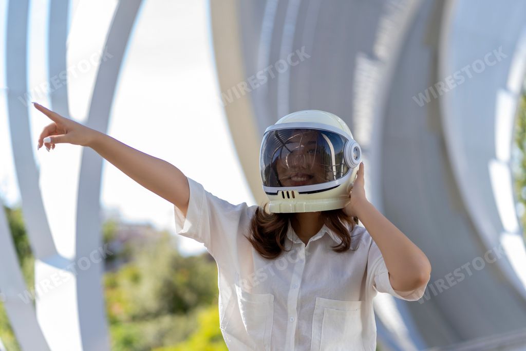 woman smiling with her astronaut costume helmet