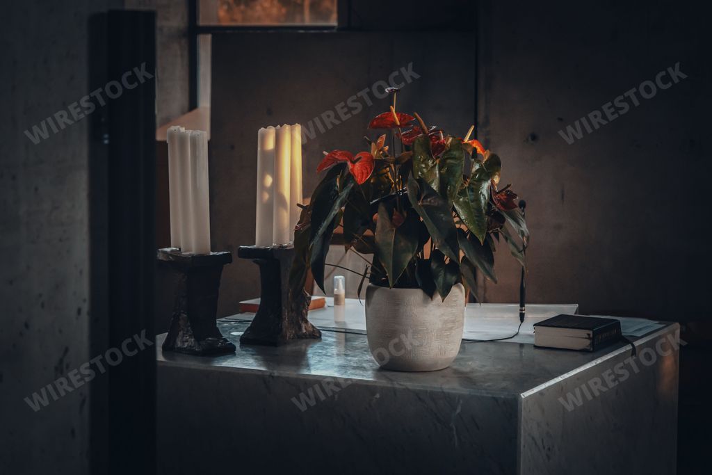 altar with flowers an candles and bible in a church