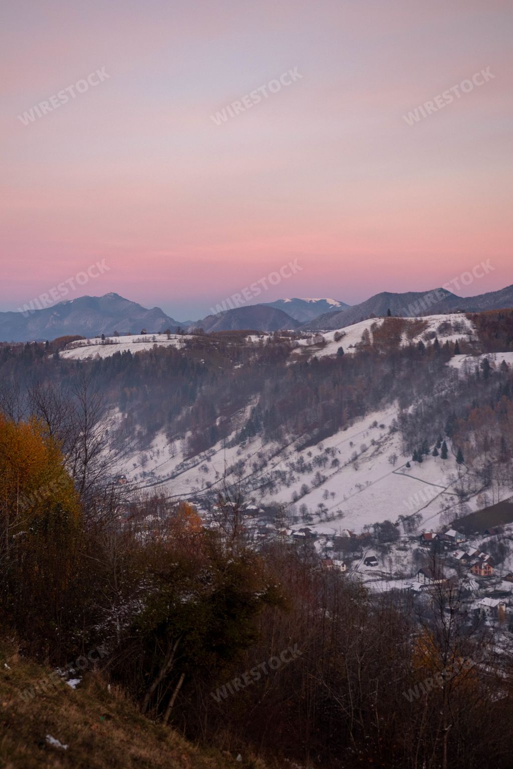 A mesmerizing scenery of snowy hills at sunset