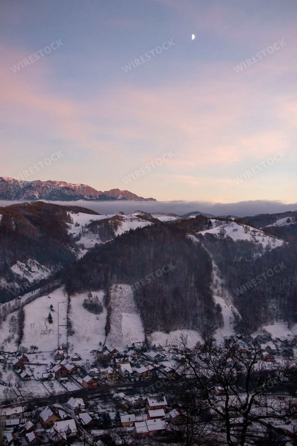 A mesmerizing scenery of snowy hills at sunse