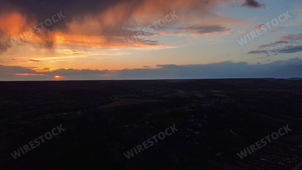 A mesmerizing sunset or sunrise with orange and cloudy sky